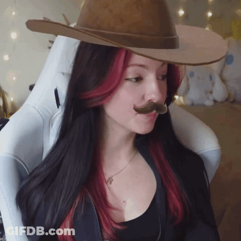 A Woman Wearing A Cowboy Hat With A Mustache On Her Face GIF