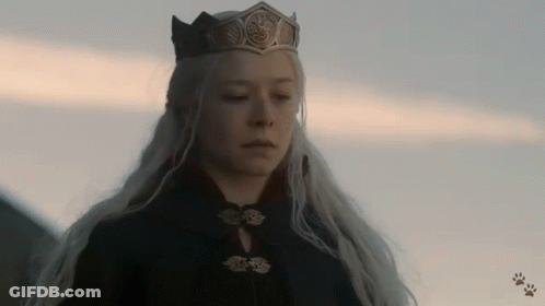 A Woman Wearing A Crown And A Black Coat GIF