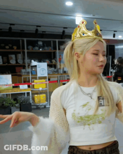 A Woman Wearing A Crown And A White Crop Top GIF