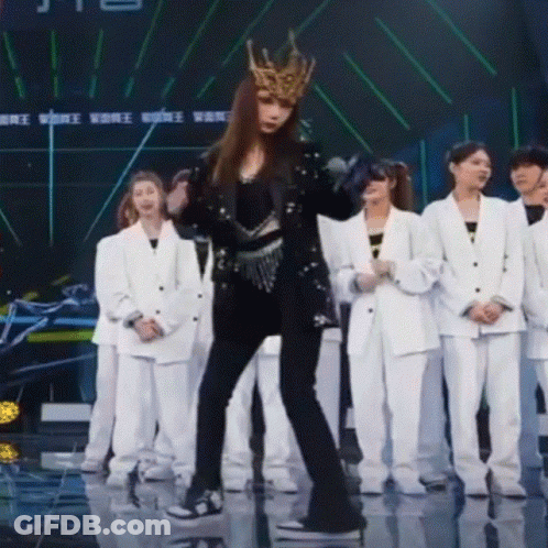 A Woman Wearing A Crown Is Dancing On A Stage GIF