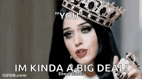 A Woman Wearing A Crown Is Pointing At The Camera And Saying `` You '' . GIF