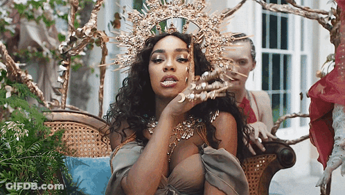 Woman Wearing Crown Sitting On Chair GIF