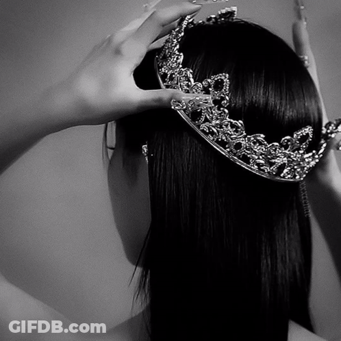 A Woman Wearing A Crown On Her Head In A Black And White Photo GIF