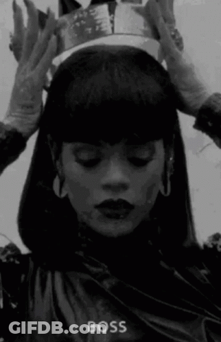 A Woman Wearing A Crown On Her Head In A Black And White Photo . GIF