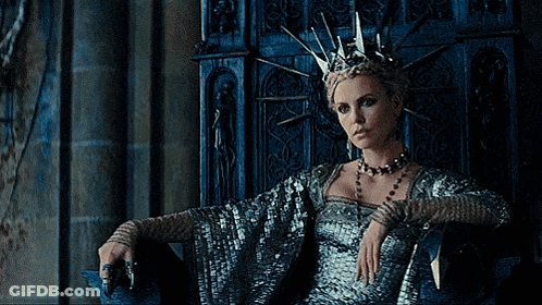 A Woman Wearing A Crown Sits In A Chair GIF