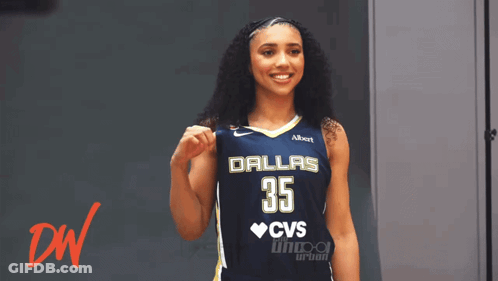A Woman Wearing A Dallas 35 Jersey Holds Her Fist Up GIF
