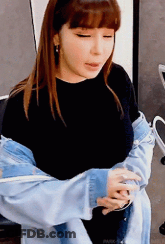 A Woman Wearing A Denim Jacket And A Black Shirt GIF