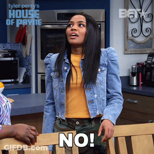 A Woman Wearing A Denim Jacket And A Yellow Shirt Says " No " GIF