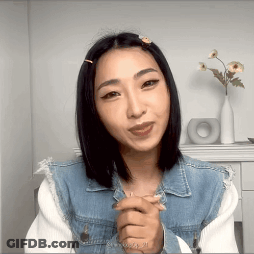 A Woman Wearing A Denim Jacket Has The Number 21 On The Bottom Of Her Picture GIF