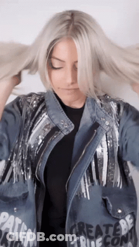 A Woman Wearing A Denim Jacket That Says Create Be True GIF