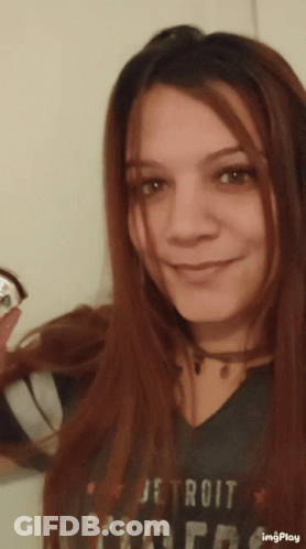 A Woman Wearing A Detroit Tigers T-Shirt Smiles For The Camera GIF