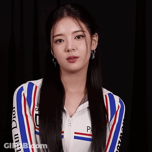 A Woman Wearing A Dior Jacket And Earrings GIF