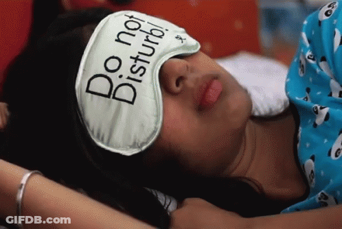 A Woman Wearing A Do Not Disturb Sleep Mask GIF