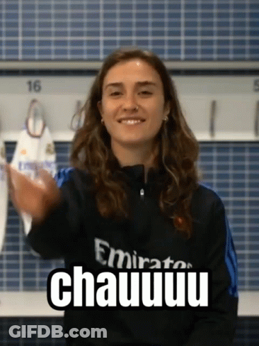 A Woman Wearing A Emirates Shirt Is Smiling And Giving A High Five GIF