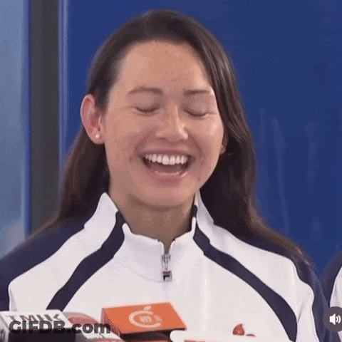A Woman Wearing A Fila Jacket Is Laughing GIF