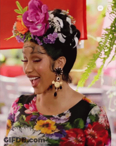 A Woman Wearing A Floral Shirt And A Flower Crown On Her Head GIF