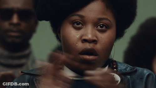 A Woman Wearing A Free Fred Hampton Badge GIF