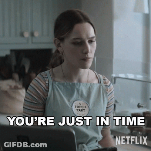 A Woman Wearing A Fresh Tart Apron Is Sitting In Front Of A Laptop And Says You 'Re Just In Time GIF
