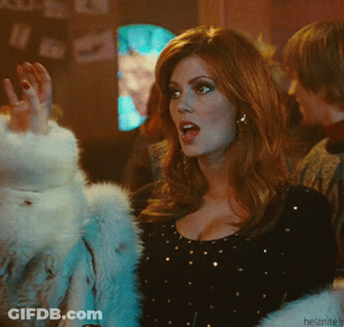 A Woman Wearing A Fur Coat And A Black Top With Gold Dots GIF