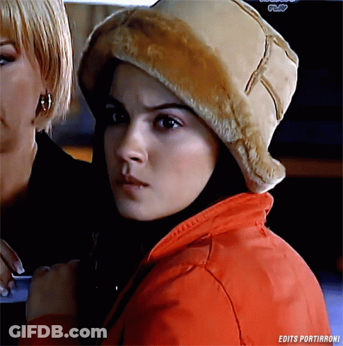 A Woman Wearing A Fur Hat And A Red Jacket With The Words Edits Portirroni On The Bottom GIF