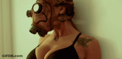 A Woman Wearing A Gas Mask With A Tattoo On Her Arm . GIF