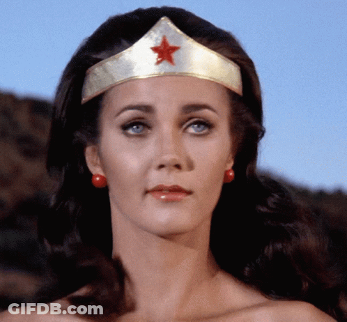 A Woman Wearing A Gold Tiara With A Red Star GIF
