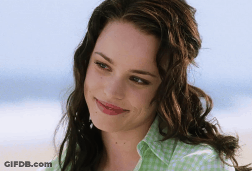 A Woman Wearing A Green And White Checkered Shirt Smiles For The Camera GIF