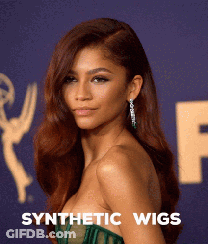 A Woman Wearing A Green Dress With Synthetic Wigs Written Below Her GIF