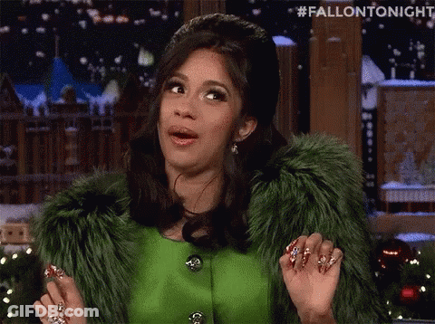 A Woman Wearing A Green Fur Coat Is Making A Funny Face . GIF