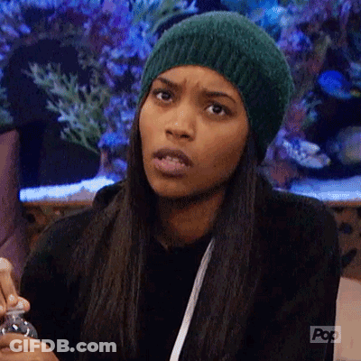 A Woman Wearing A Green Hat Is Making A Funny Face While Holding A Bottle . GIF