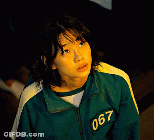 A Woman Wearing A Green Jacket With The Number 067 On The Sleeve GIF