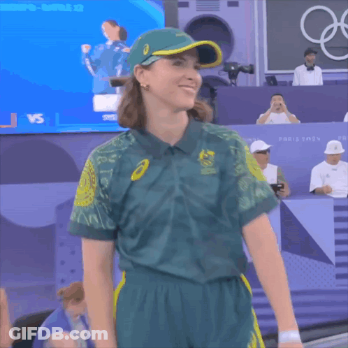 A Woman Wearing A Green Shirt That Says Australia Olympics On It GIF