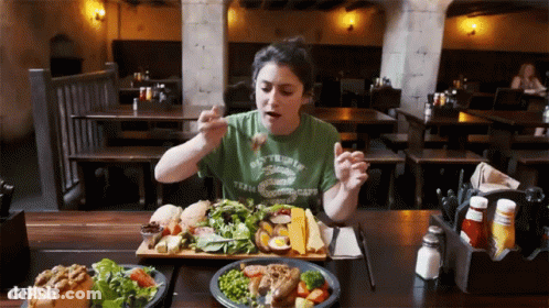 A Woman Wearing A Green Shirt That Says Slytherin On It GIF