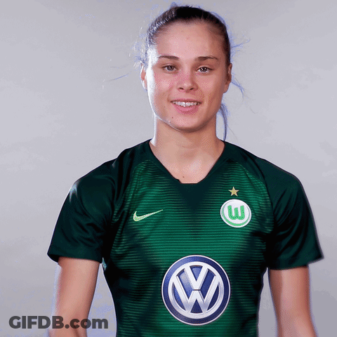 A Woman Wearing A Green Shirt With A Vw Logo GIF