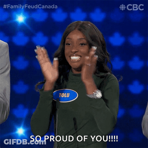A Woman Wearing A Green Sweater With The Name Tolu On It Applauds GIF
