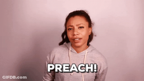 A Woman Wearing A Grey Hoodie With The Word Preach Written On It GIF