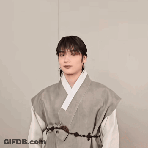 A Woman Wearing A Grey Kimono With A White Collar GIF