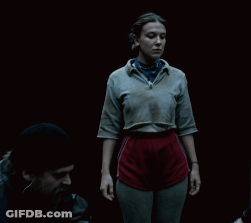 A Woman Wearing A Grey Shirt And A Blue Bandana GIF