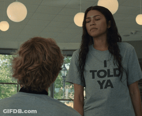 A Woman Wearing A Grey T-Shirt That Says I Told Ya GIF