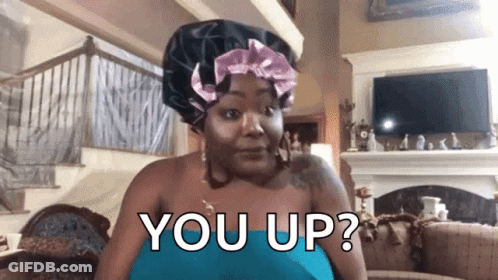 A Woman Wearing A Hair Bonnet Is Sitting In A Living Room And Asking You Up ? GIF