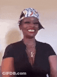 A Woman Wearing A Hat And A Black Shirt Smiles GIF