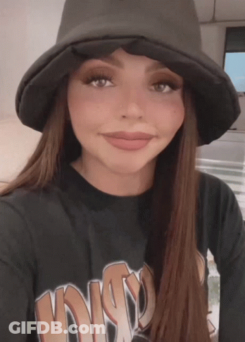 A Woman Wearing A Hat And A Black Shirt That Says Disco GIF
