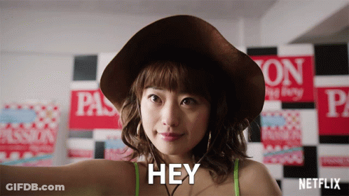 Woman In Hat And Green Top Says Hey GIF