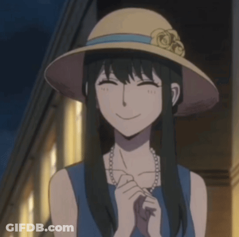 A Woman Wearing A Hat And A Pearl Necklace Smiles For The Camera GIF