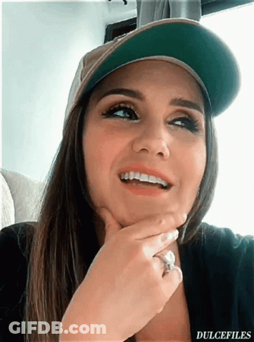 A Woman Wearing A Hat And A Ring Has The Word Dulcefiles On The Bottom Right GIF