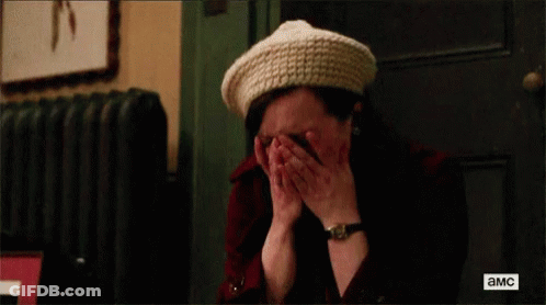 A Woman Wearing A Hat And A Watch Is Crying . GIF