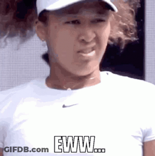 A Woman Wearing A Hat And A White Shirt Is Making A Funny Face And Says Eww . GIF