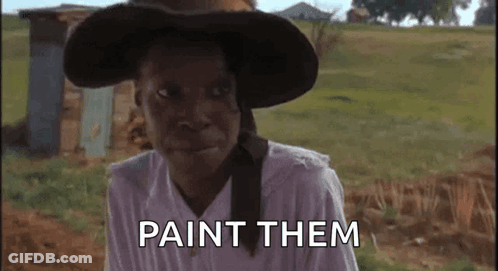A Woman Wearing A Hat And A White Shirt Says Paint Them GIF