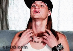 A Woman Wearing A Hat And A White Tank Top Has The Word Rage On Her Chest GIF