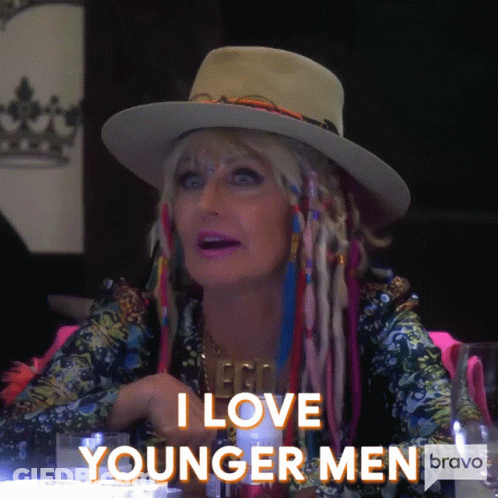 A Woman Wearing A Hat And Dreadlocks Says I Love Younger Men GIF